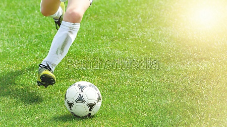Football Player Compete For a Ball. Children Playing Sports on Grass Pitch. Closeup Image of Youth Football Competition Match. detail photo