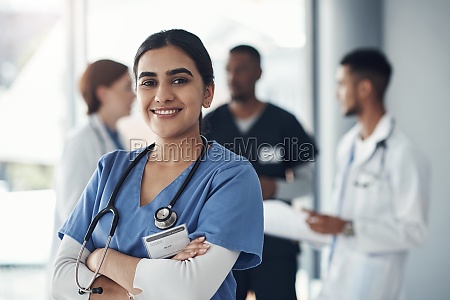 Only a life lived for others is a life worthwhile. a young female doctor standing in the office of a hospital