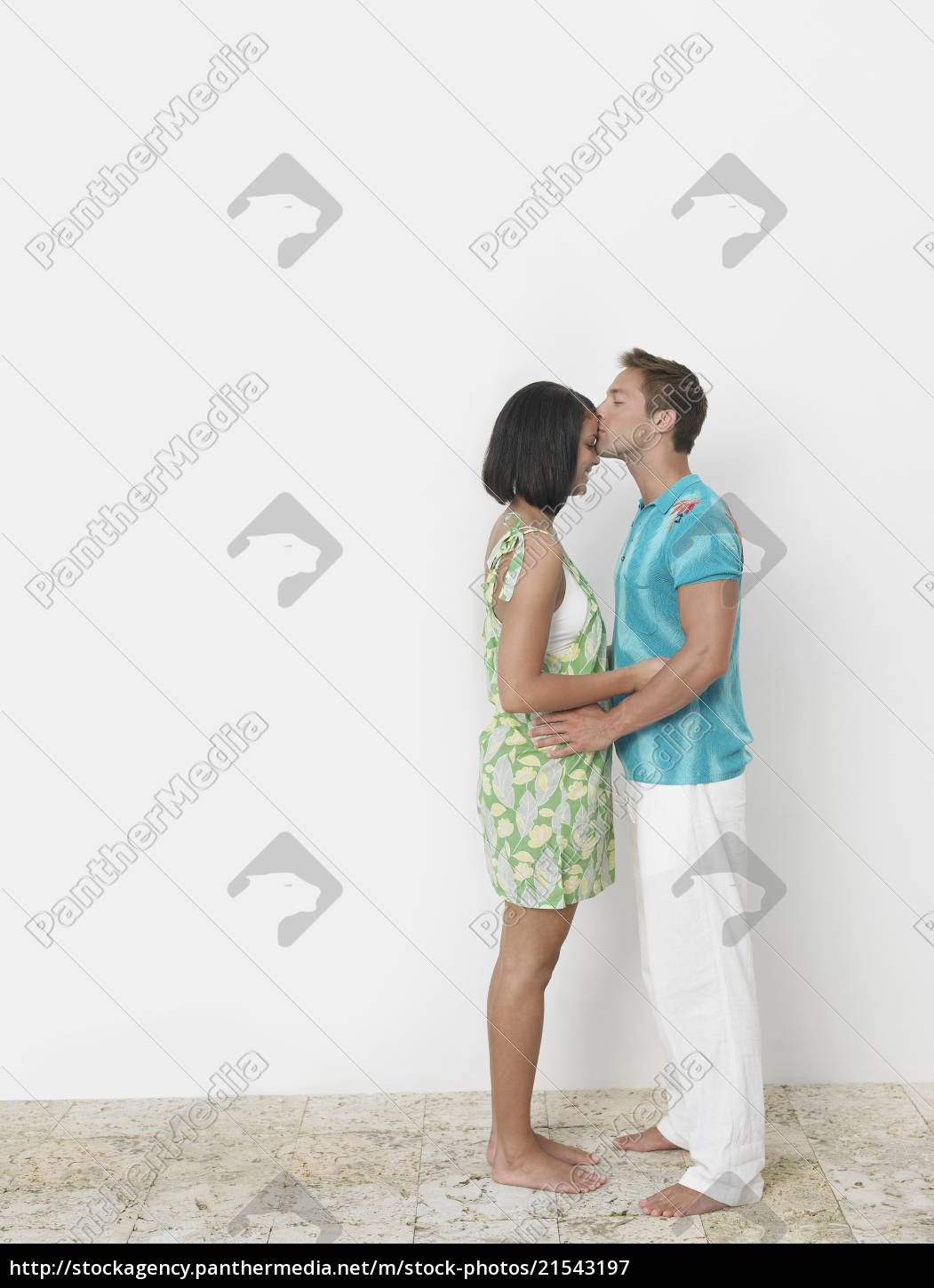 Loving young man kissing woman s forehead against wall - Stock Photo  #21543197 | PantherMedia Stock Agency