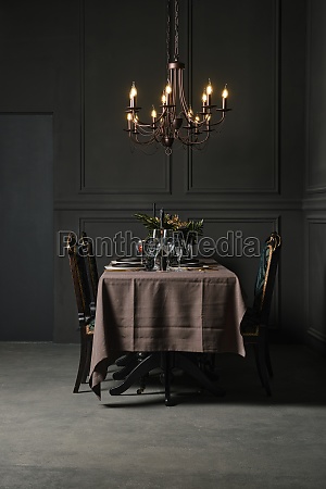 Low key photo of dining table with candlelight